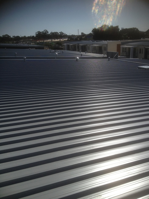 Standing-seam COLORBOND metal roof on a multi-storey apartment building in Perth