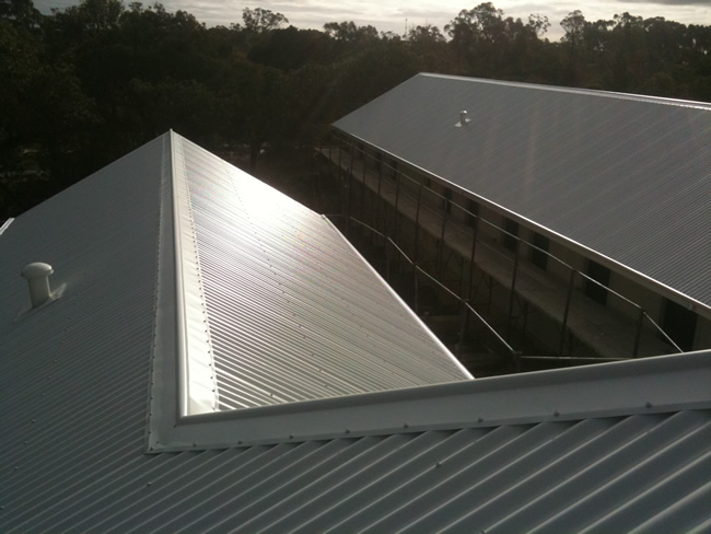 Industrial metal roof and wall cladding on a large steel-framed building in Western Australia