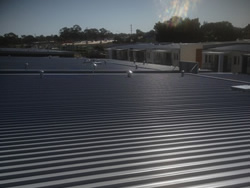 Standing-seam metal roof on a Perth apartment building